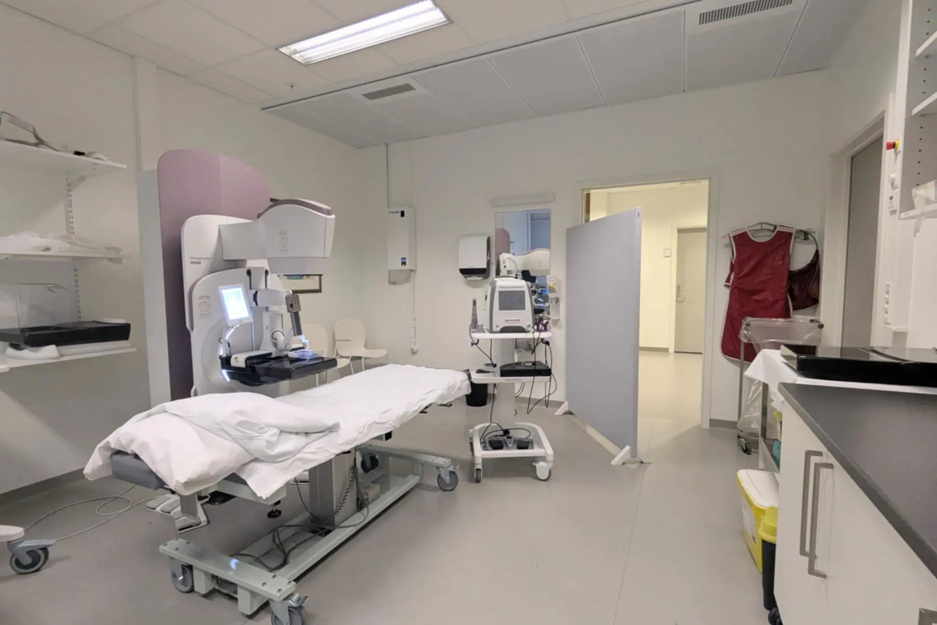 A hospital room with a bed and medical equipment
