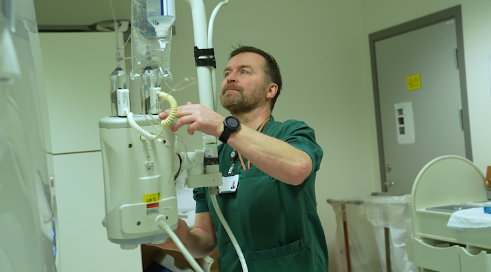 En mann som holder en kontrastveskemaskin