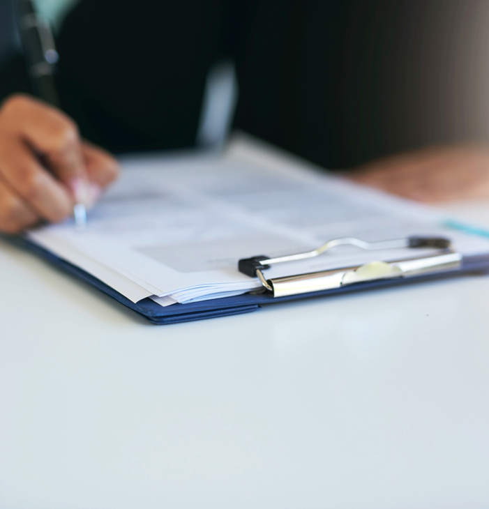A person writing on a piece of paper