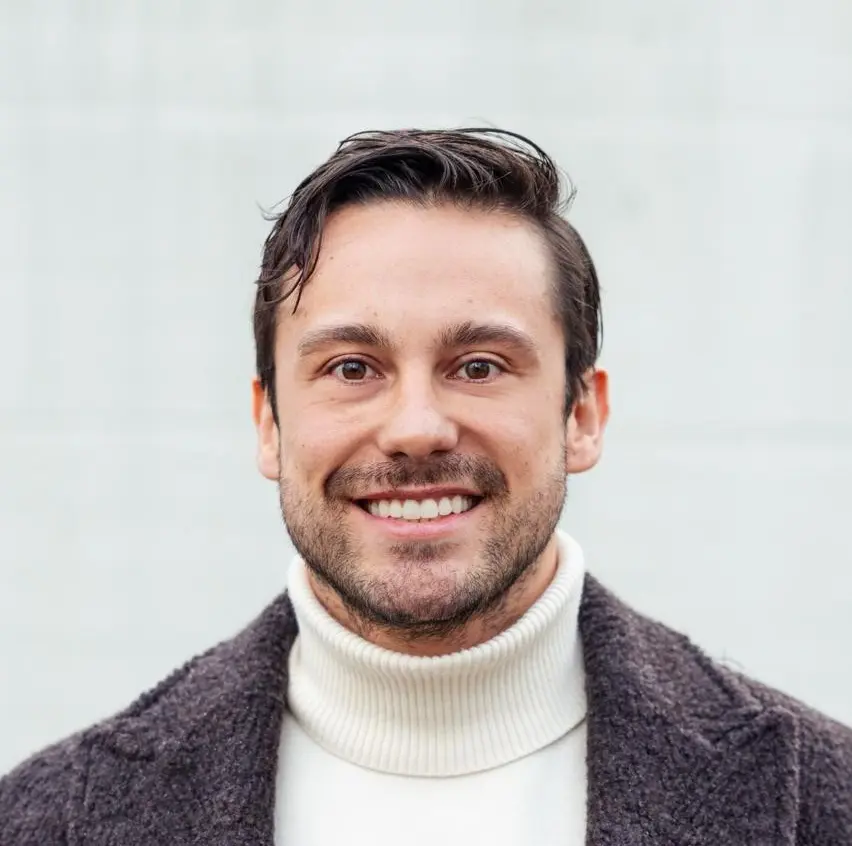 En mann iført en grå genser