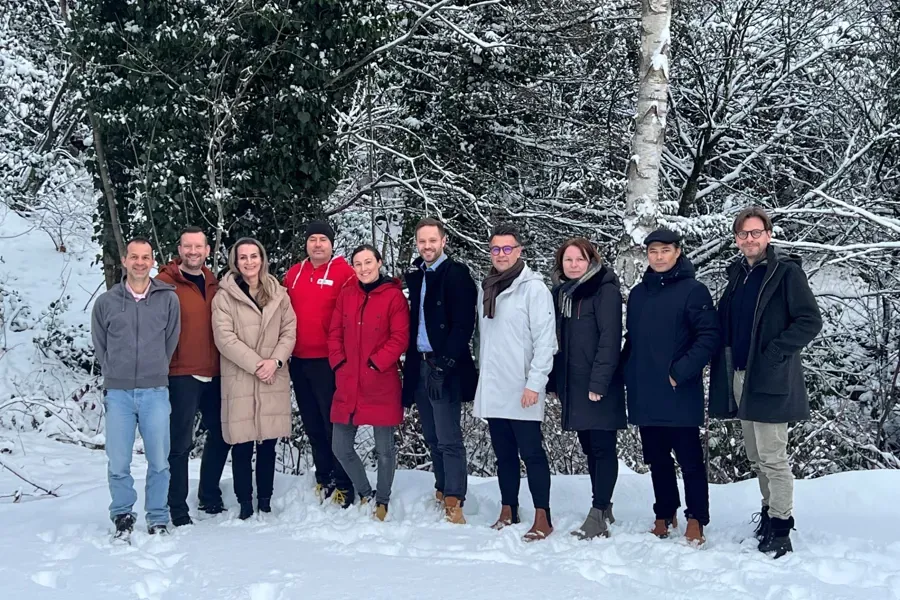 A group of people standing in the snow