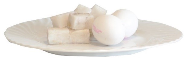 A white egg on a white plate