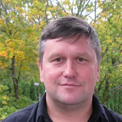 En mann som står foran trær