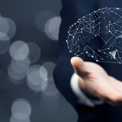 Hands holding an illustration of a human brain