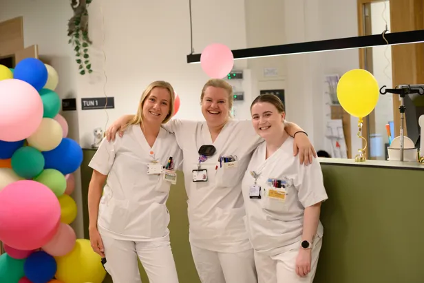 En gruppe mennesker som poserer for et bilde med ballonger