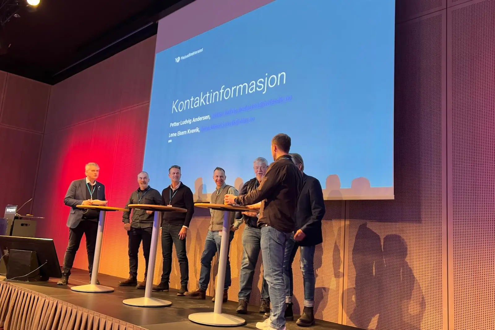 A group of men standing on a stage