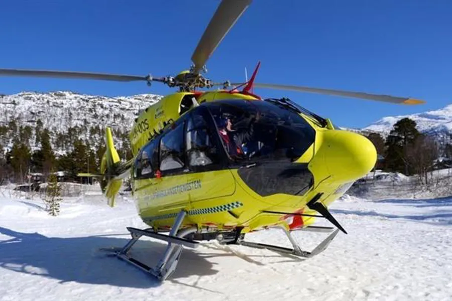 A yellow helicopter on snow