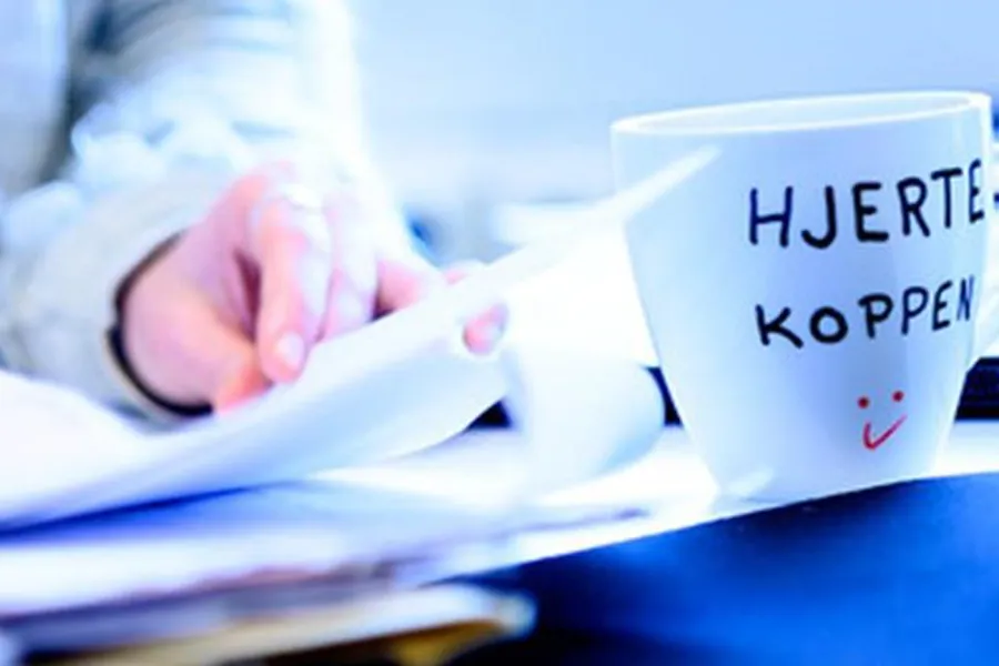 A hand holding a coffee cup